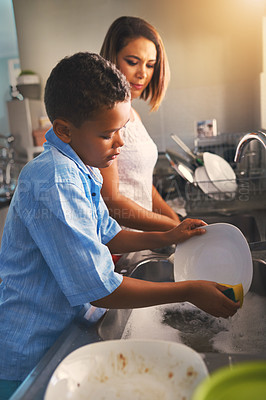 Buy stock photo Shot of a mother and son washing dishes together