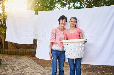 Buy stock photo Portrait of a mother and daughter hanging up laundry together outside