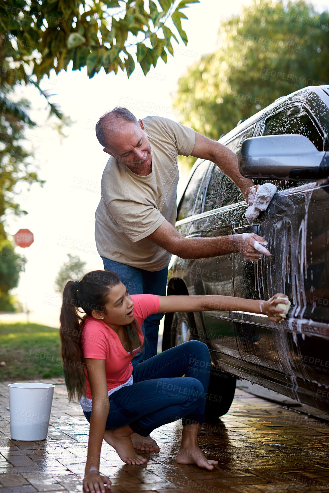 Buy stock photo Father, girl and car washing for cleaning, learning responsibility and development outdoor. Child, kid or children and dad for busy routine, childhood and cute for soap water or fun on weekend