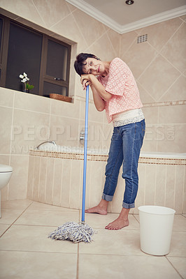 Buy stock photo Woman, mop and tired for burnout, stress and worry in bathroom for depression and responsibility. Young person, standing or  rest with stick for break, moody or anxiety in house for distress or grief