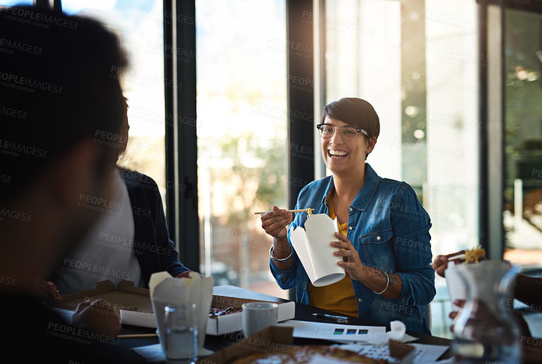 Buy stock photo Creative, business people and woman in meeting with fast food, smile and collaboration together. Eating, lunch and happy design team in workshop for development plan, growth and solidarity in office