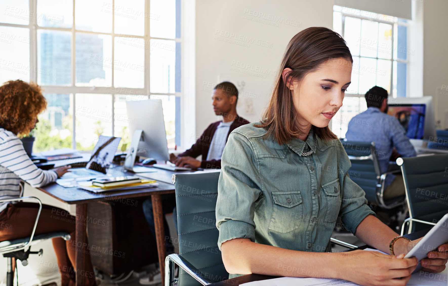 Buy stock photo Woman, reading tablet and focus in office at web design startup with ideas, planning and job schedule. Tech vision, gen z developer and coworking for app ux, website and mobile touchscreen at desk