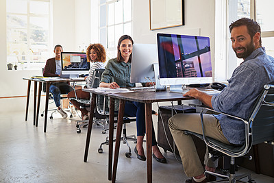Buy stock photo Portrait of colleagues working on their computers in an open plan office