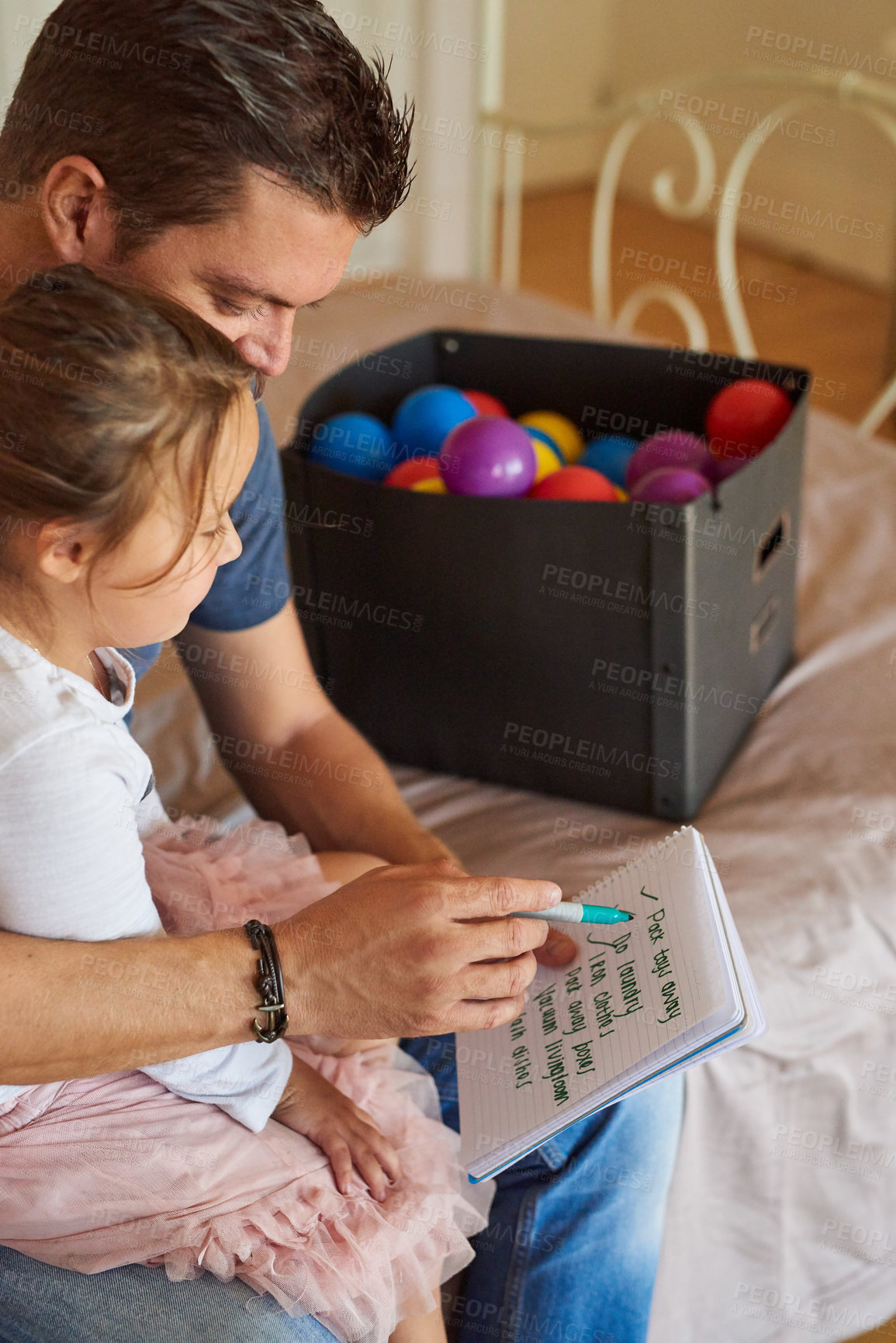 Buy stock photo Shot of a father going through a list of chores with his daughter