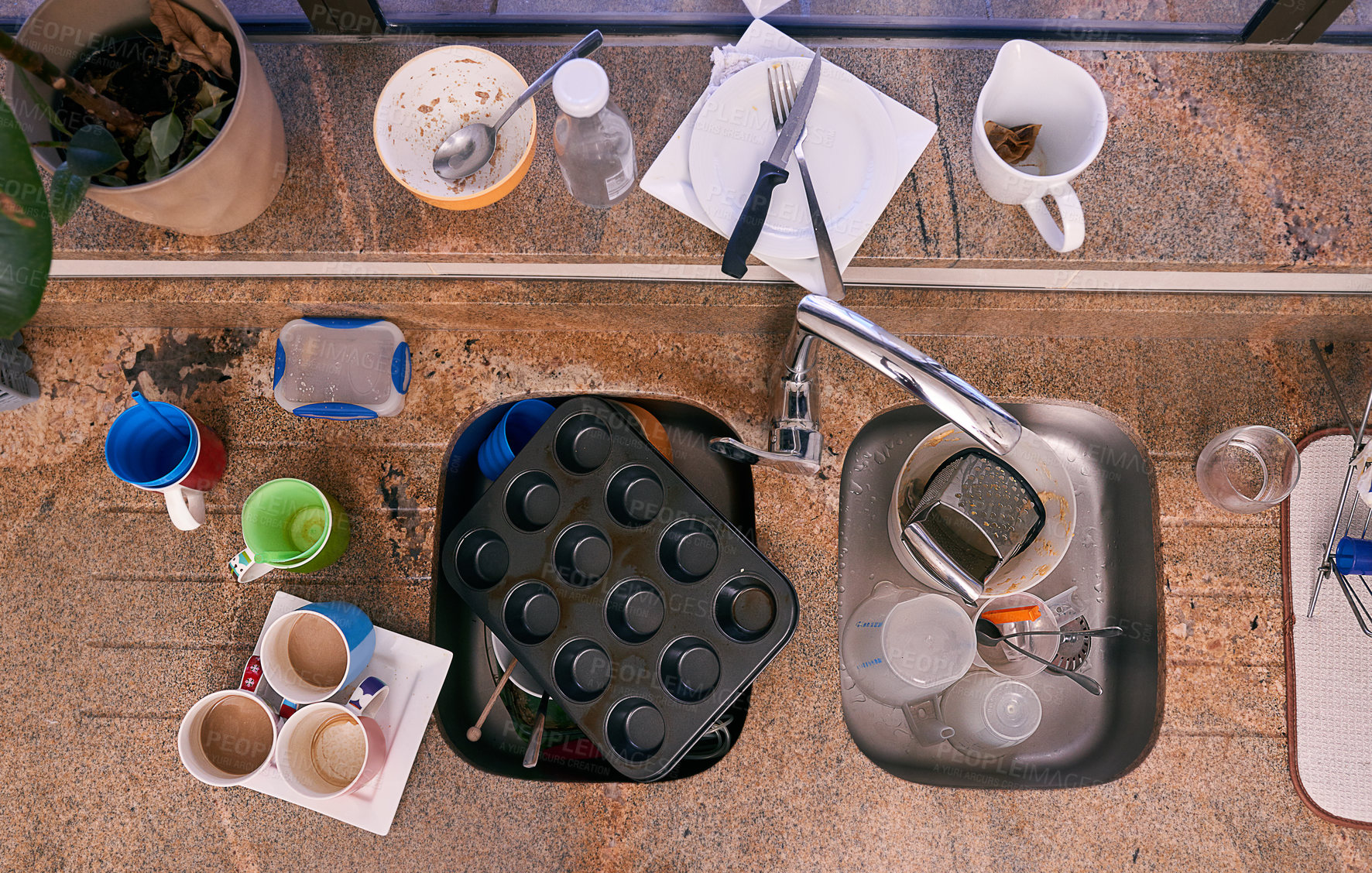 Buy stock photo Top view, dirt and kitchen with dishes, chaos and knife on counter on a background in home for chores. Above, sink and unclean utensils, baking and garbage mess with glass cups in water for housework