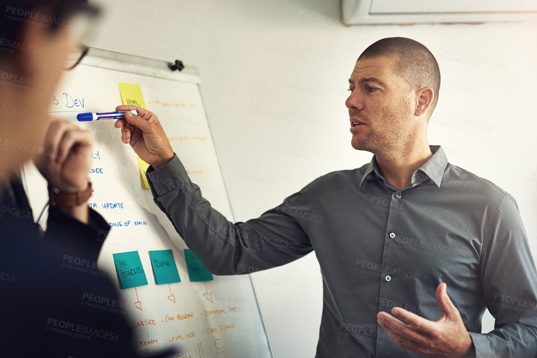 Buy stock photo Shot of a man giving a presentation to colleagues in an office