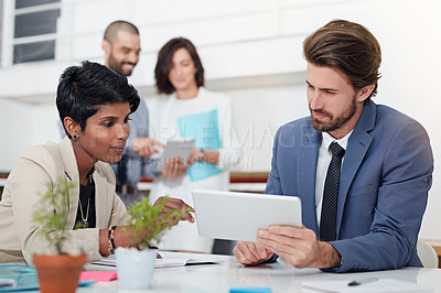 Buy stock photo Shot of businesspeople using digital tablets in an office meeting