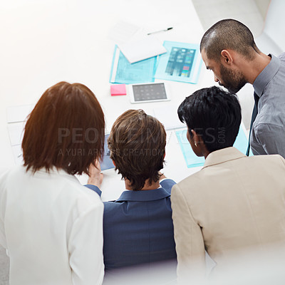 Buy stock photo Shot of businesspeople crowding around a digital tablet in an office meeting