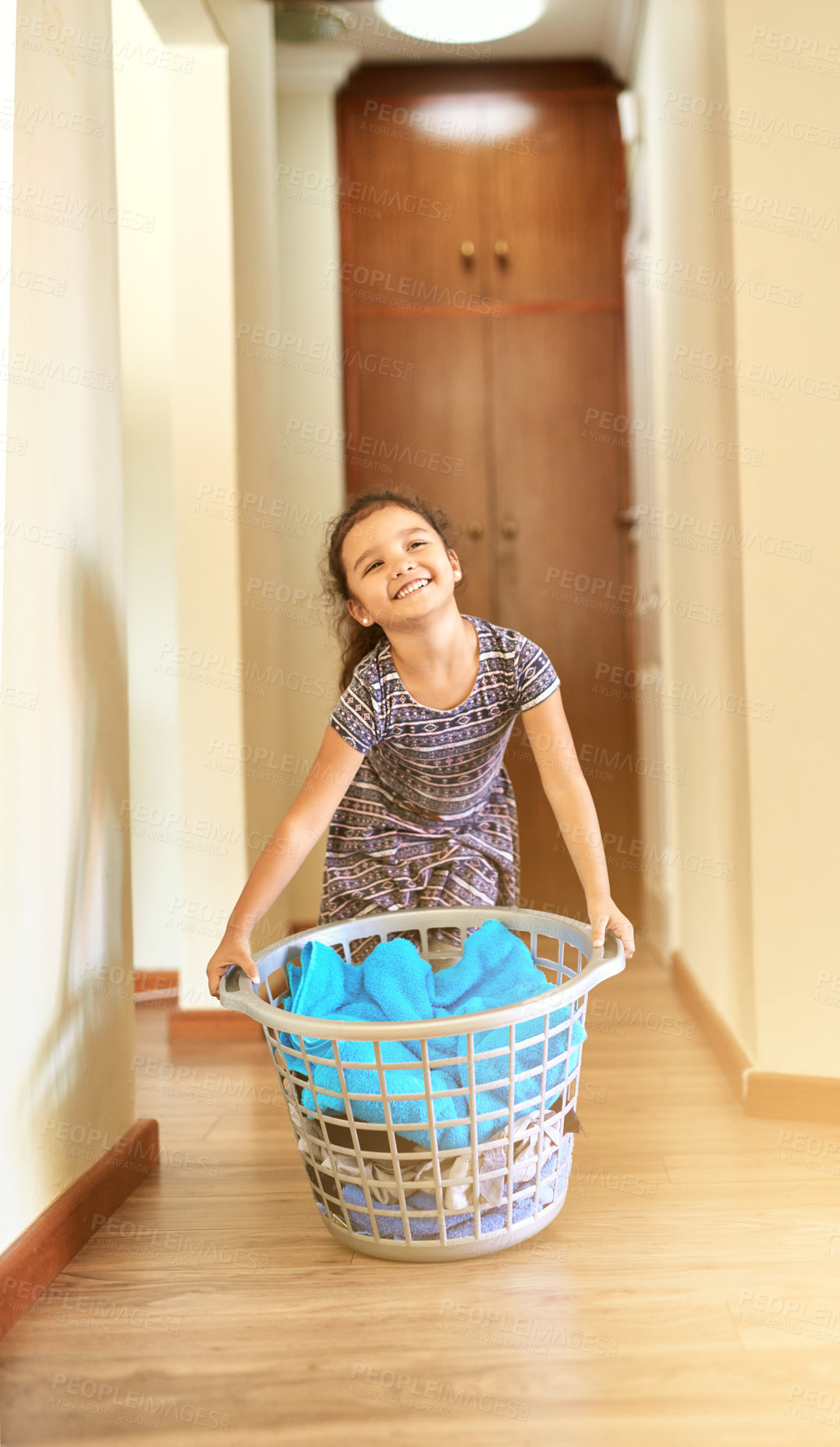 Buy stock photo Shot of a young girl holding a basket of laundry