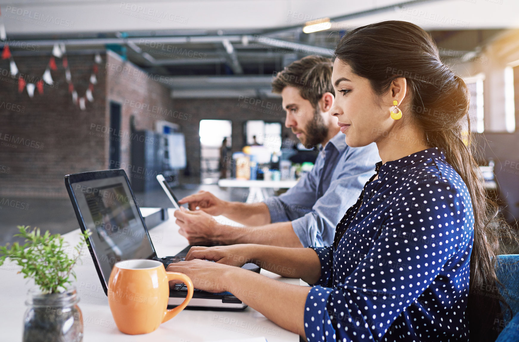 Buy stock photo Coworking, office and woman typing on laptop at desk with man at creative agency working on project together. Digital, partnership and employees or business people at computer at design startup.