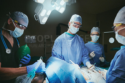 Buy stock photo Cropped shot of surgeons in an operating room