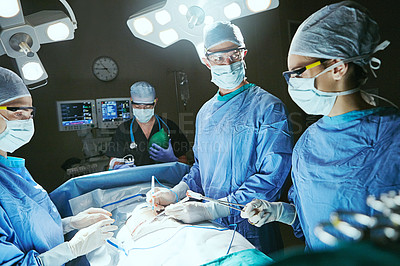 Buy stock photo Cropped shot of surgeons in an operating room