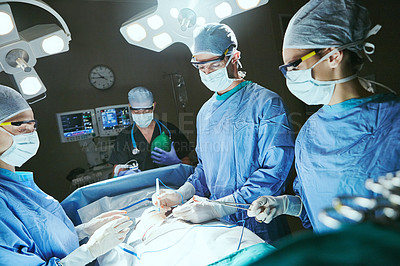 Buy stock photo Cropped shot of surgeons in an operating room