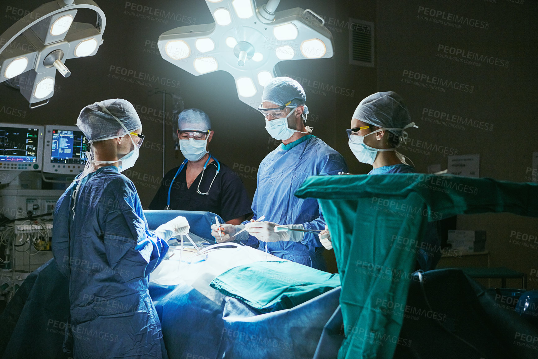 Buy stock photo People, collaboration and patient for operation, teamwork and support for healthcare. Dark, hospital theater and surgeons with tools, procedure and surgery for cardiology and treatment in ICU clinic