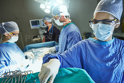 Buy stock photo Cropped shot of surgeons in an operating room