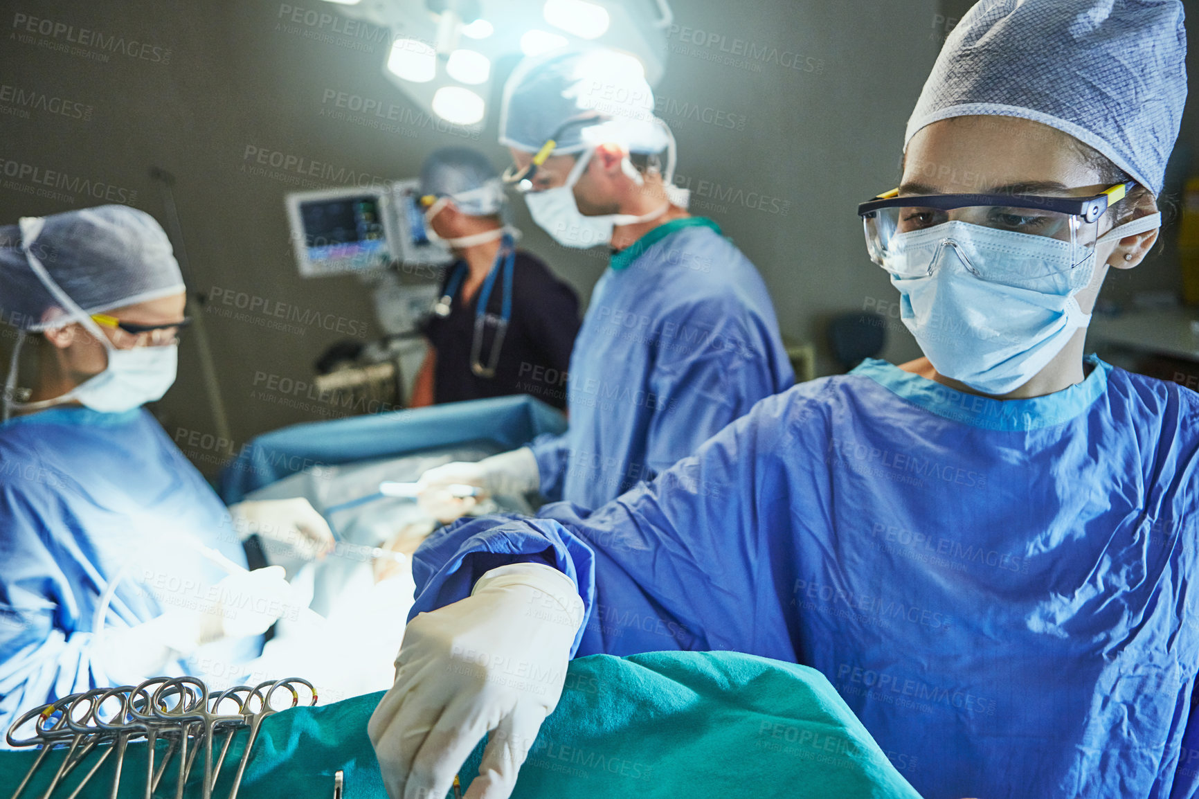 Buy stock photo People, doctor and operating room with tools or patient for surgery or emergency in hospital or ICU. Medical team, surgeon or help with face mask for health safety, procedure or save a life in scrubs