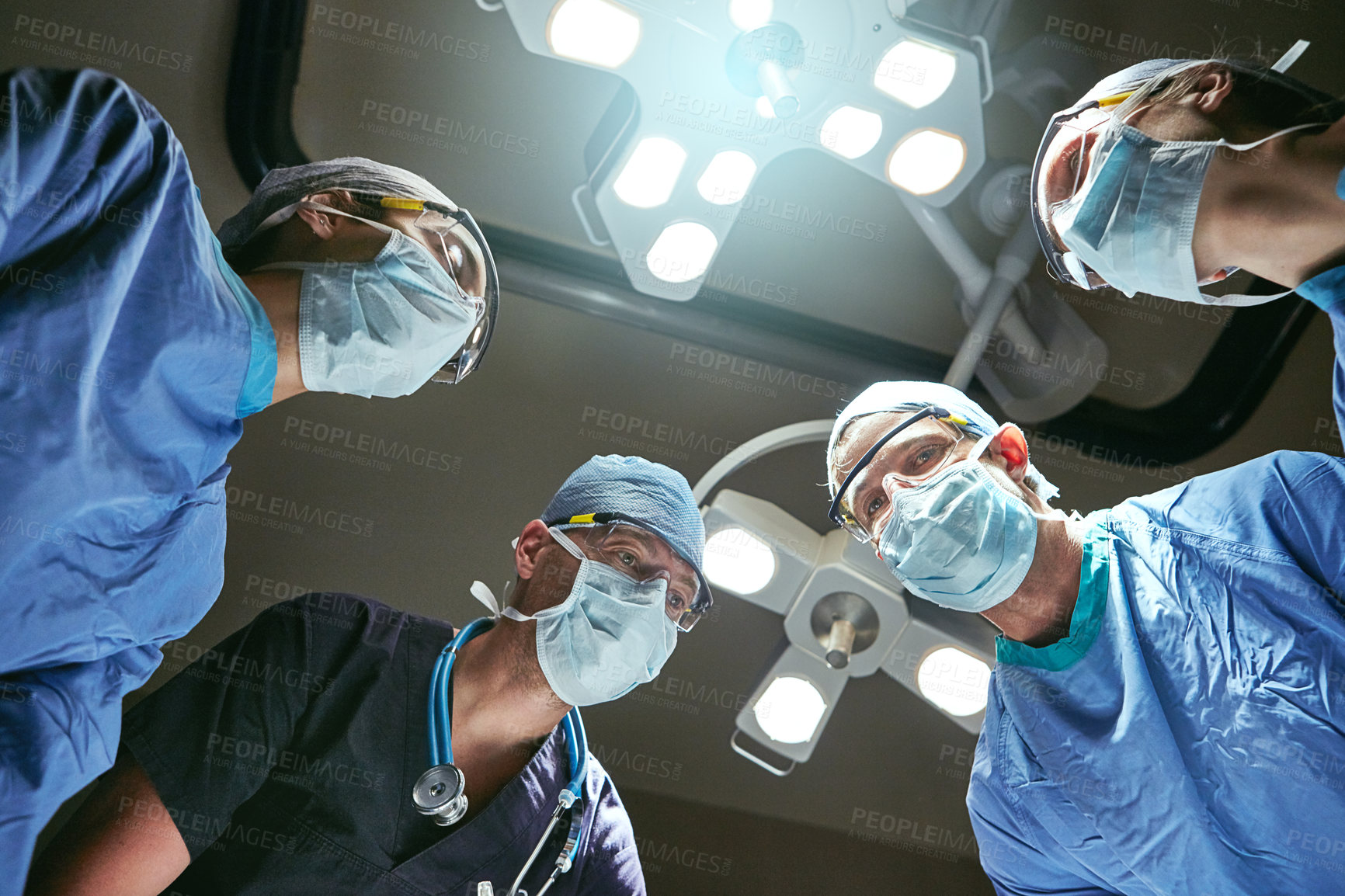 Buy stock photo Hospital, teamwork and low angle of doctors in surgery for emergency crisis, medical service and procedure. Healthcare, discussion and surgeons with patient pov for injury, operation or ICU treatment