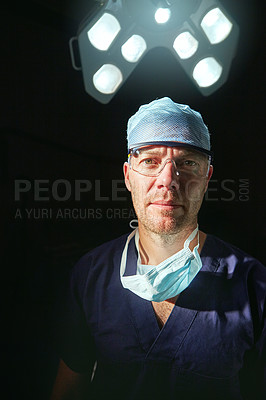 Buy stock photo Cropped portrait of a male doctor against a dark background