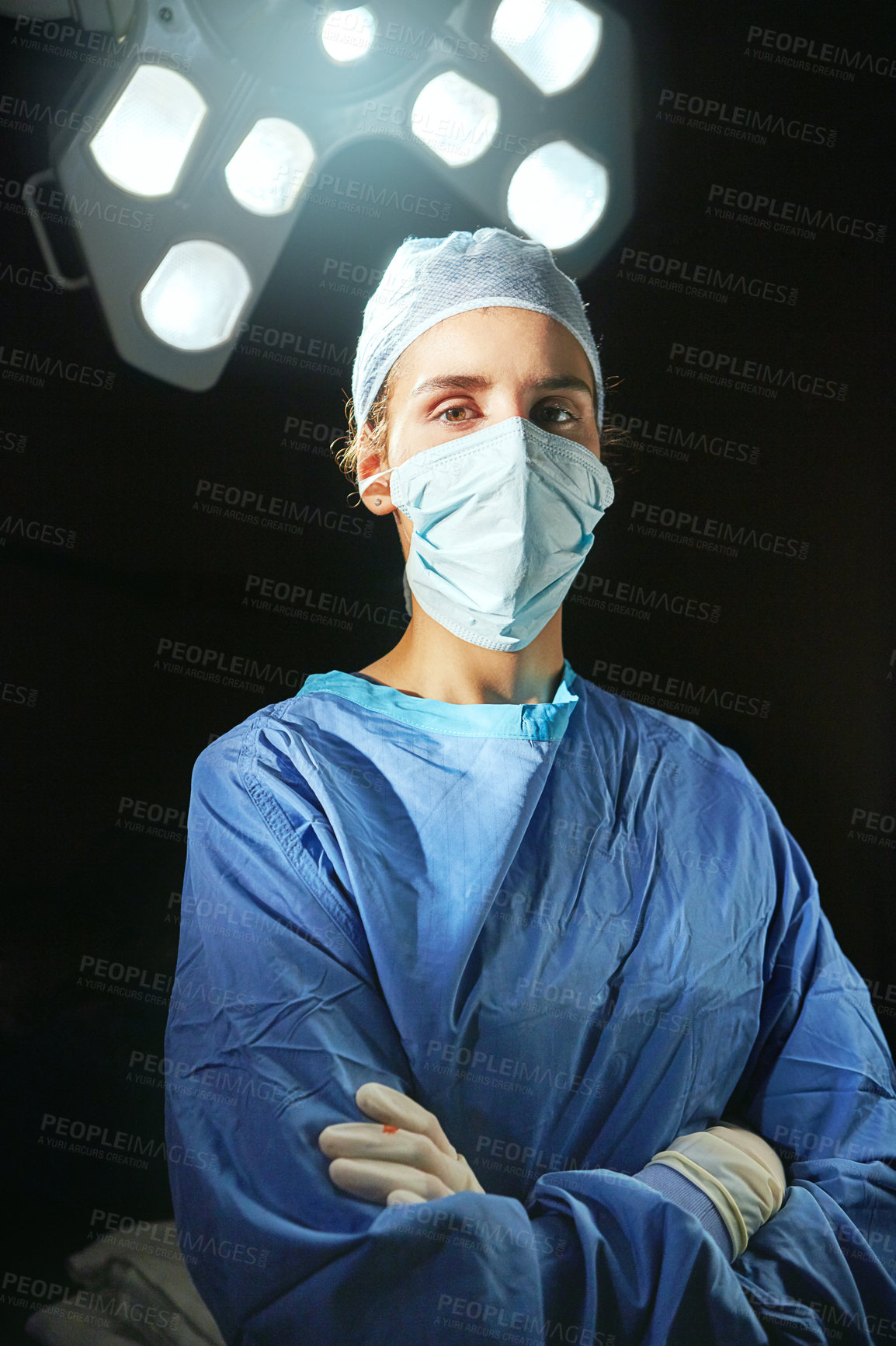 Buy stock photo Cropped portrait of a female doctor against a dark background