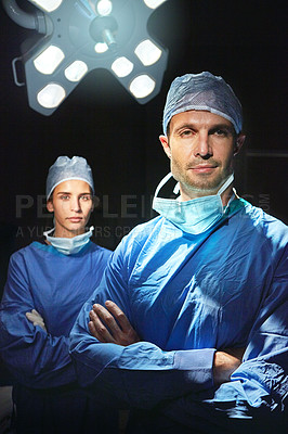 Buy stock photo Cropped portrait of two doctors against a dark background
