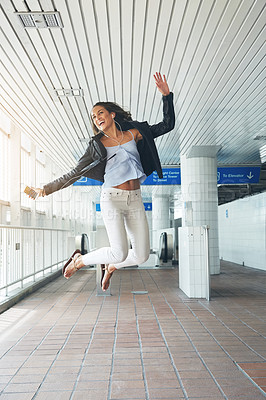 Buy stock photo Shot of a young woman jumping in an urban setting