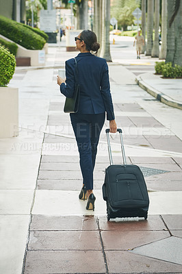 Buy stock photo Rearview shot of a businesswoman on the move in the city