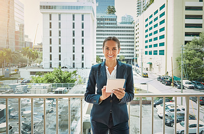 Buy stock photo Portrait of a young businesswoman using a digital tablet on her way to the office