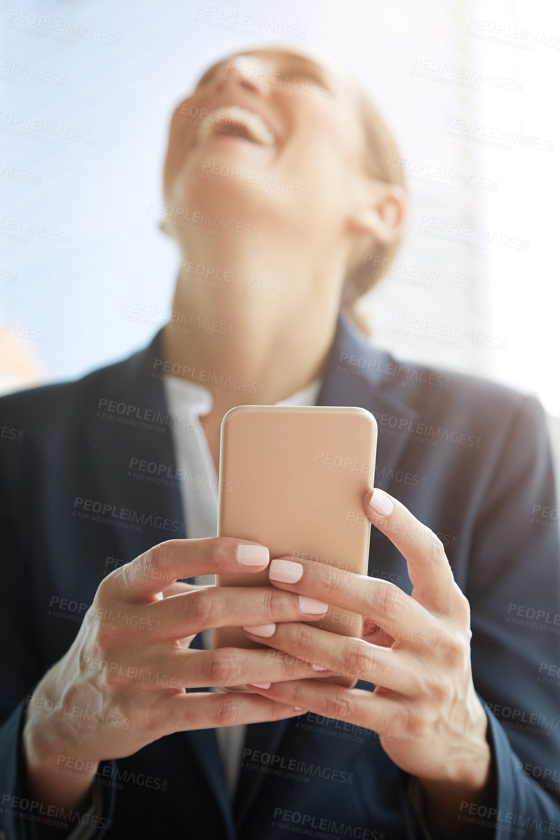 Buy stock photo Shot of a young businesswoman laughing while using a cellphone