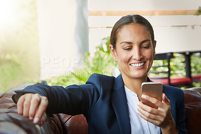 Buy stock photo Shot of a young businesswoman using a cellphone