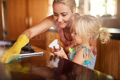 Buy stock photo Cropped shot of a mother and daughter cleaning the kitchen together