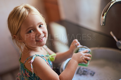 Buy stock photo Kitchen, portrait and girl child washing dishes with smile, learning or help at basin in home. Housework, growth and kid cleaning at sink with development, pride and happy morning housekeeping chores