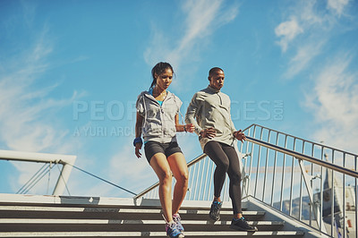 Buy stock photo Outdoor, couple and running on stairs for fitness, physical health and training for marathon as team. Blue sky, man and woman on steps for exercise session, cardio and wellness with endurance in city