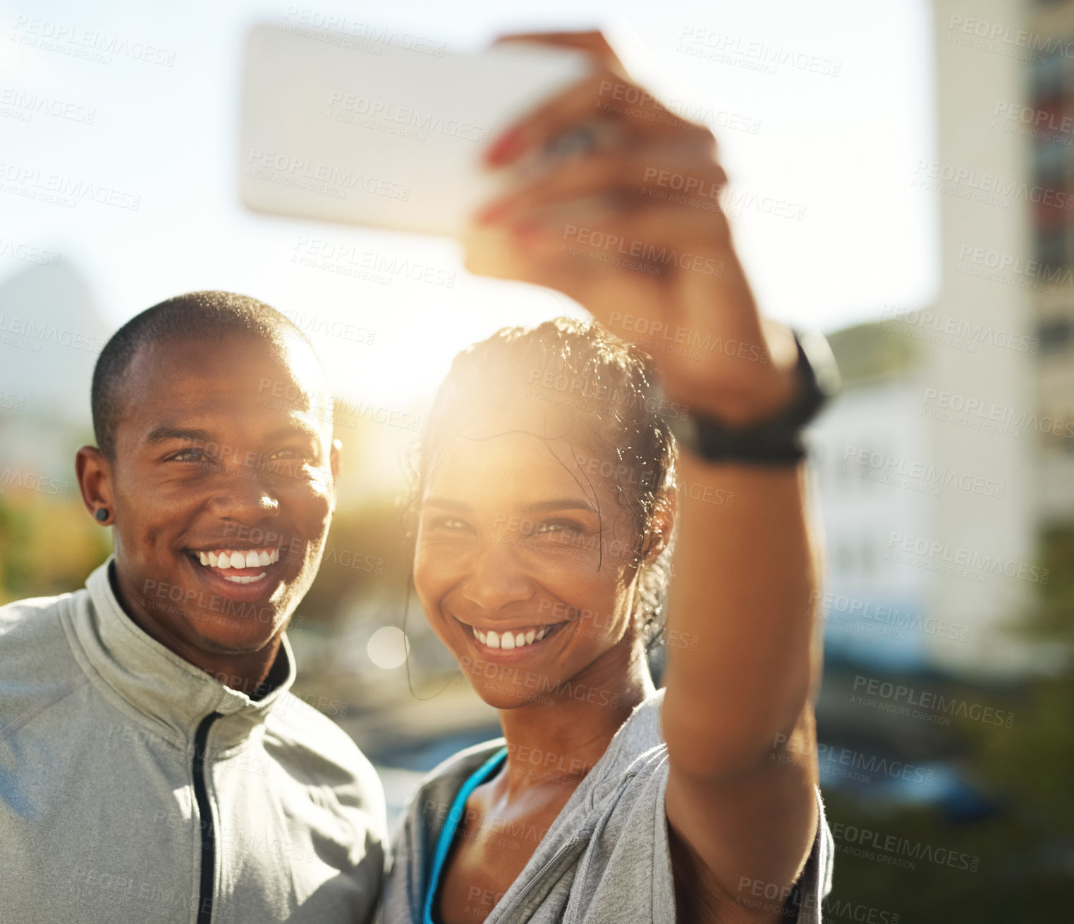 Buy stock photo Shot of a young sporty couple taking a photo together with a cellphone