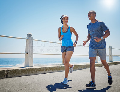 Buy stock photo Shot of a young sporty couple out for a run together