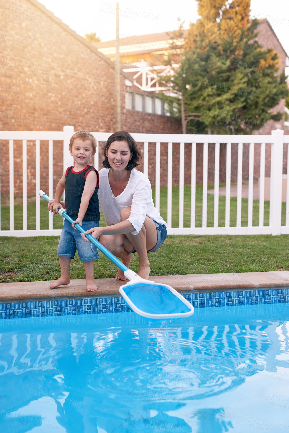 Buy stock photo Mother, son and net for cleaning pool in backyard, chore and teaching kid responsibility in outdoors. Happy mommy, boy and help with housework or bonding in garden, toddler and support with learning