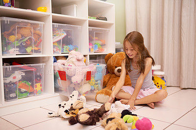 Buy stock photo Shot of a young girl playing with toys in a room