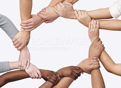 Buy stock photo Cropped shot of a diverse group of hands joined together
