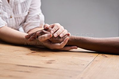 Buy stock photo Support, forgiveness and people holding hands for empathy, love and trust. Help, table and diversity with a helping hand from life coach, care of friends and showing compassion for mental health