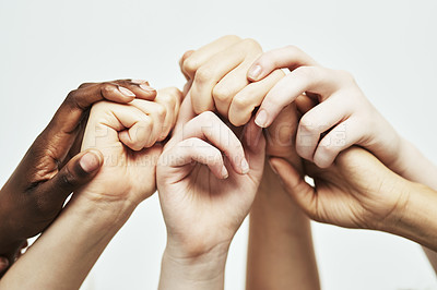 Buy stock photo Shot of a group of hands holding onto each other against a white background