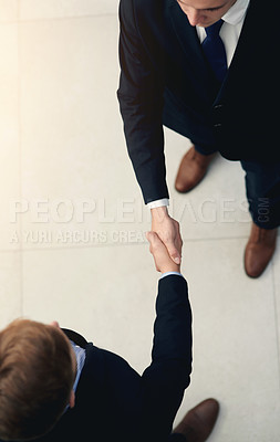 Buy stock photo Business men, handshake and partnership in meeting for b2b deal, agreement or collaboration in office. Above view, professional and people shaking hands for greeting, introduction or thank you