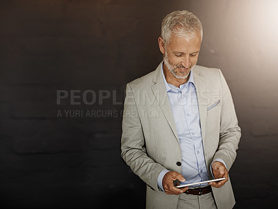 Buy stock photo Mature, business and man with tablet in studio for reading email, financial planning or communication update. Smile, male accountant and digital for review, project and budget chat on dark background