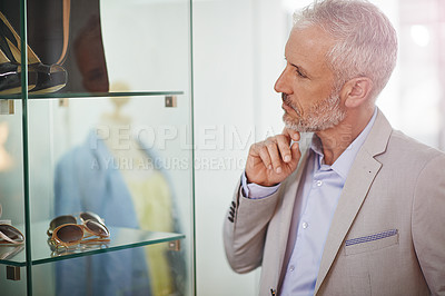 Buy stock photo Shot of a mature man window shopping in a mall