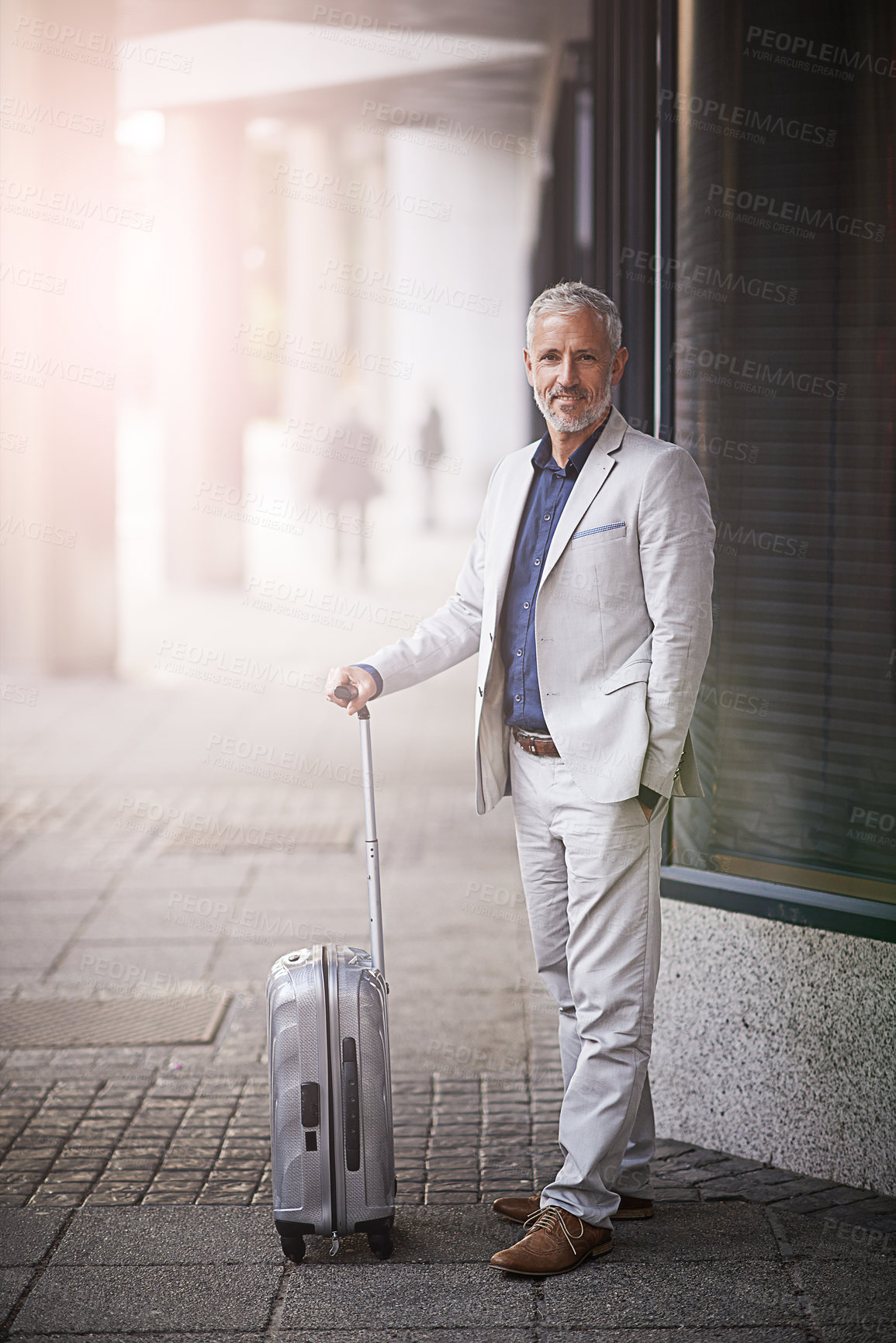 Buy stock photo Portrait of a mature businessman standing with a suitcase outside