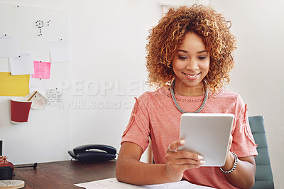 Buy stock photo Cropped shot of a designer using her tablet at the office