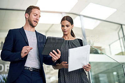 Buy stock photo Cropped shot of two colleagues walking together in the office
