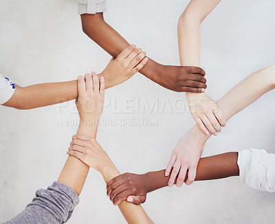 Buy stock photo Shot of a group of hands holding on to each other