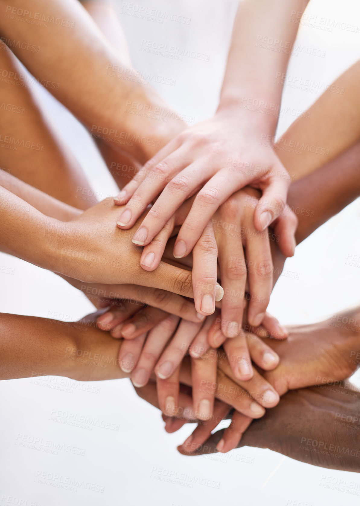 Buy stock photo Shot of a group of people putting their hands together