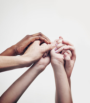 Buy stock photo Shot of a group of hands holding on to each other against a white background