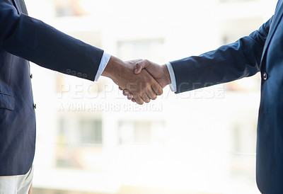 Buy stock photo Shot of two unidentifiable businessmen shaking hands in the office