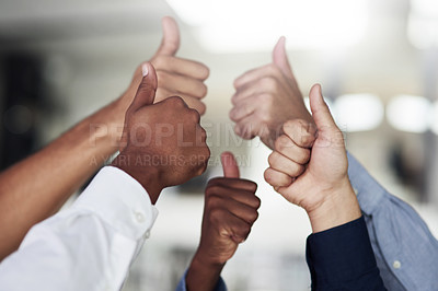 Buy stock photo Shot of a group of unidentifiable businesspeople showing thumbs up in the office